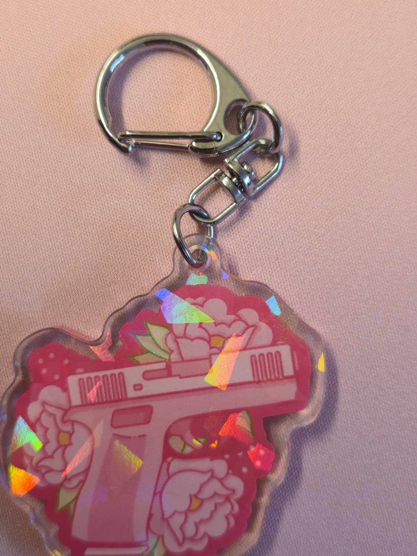 Keychain with a colorful design on a pink background