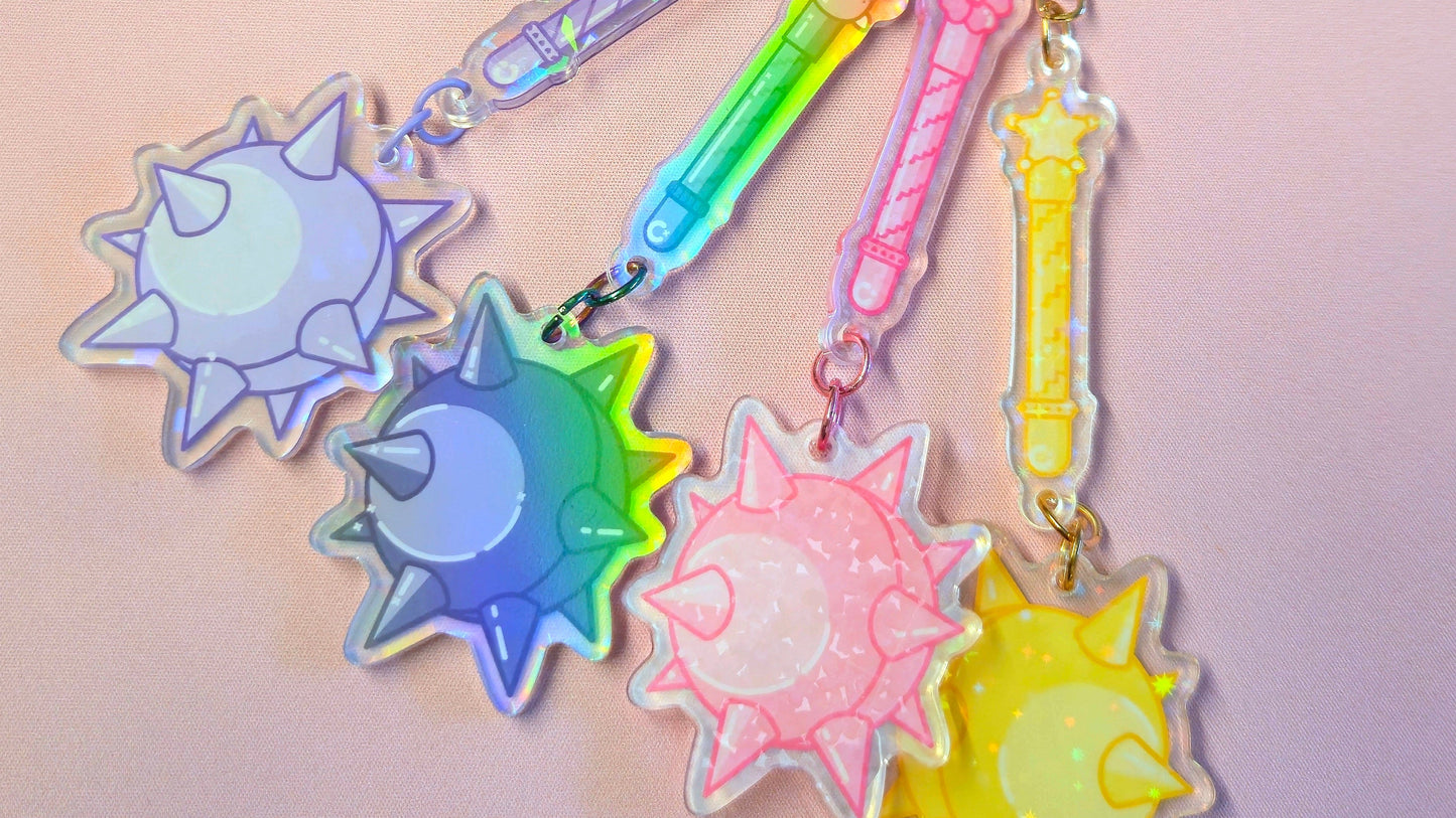 Colorful keychain with sun-shaped charms on a light pink background