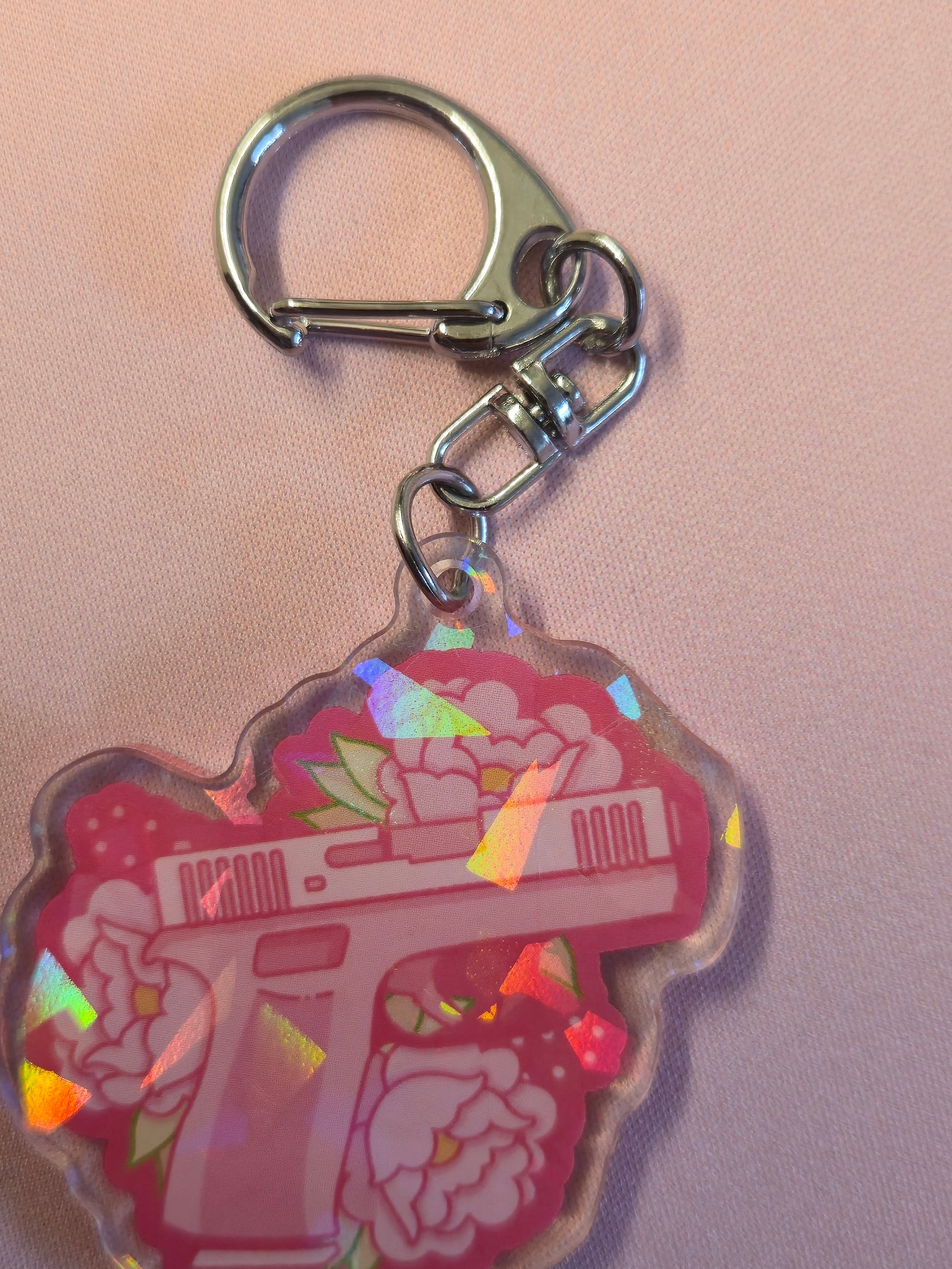 Keychain with a colorful design on a pink background