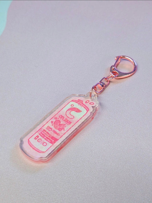 Pink keychain with a cartoon design on a light gray background